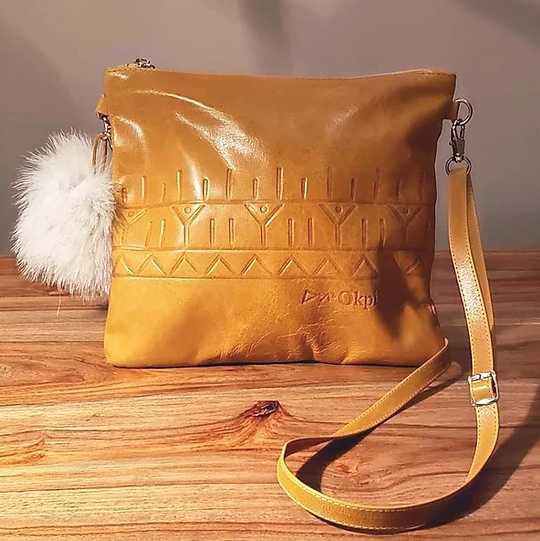 Leather purse with tunniit emboss and fox fur pom pom