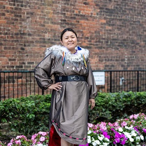 Brown "Caribou" Dress (2023) with Amaruq Sunburst Collar (2024) and Seal Heart Rainbow Fringe Earrings (2023)
