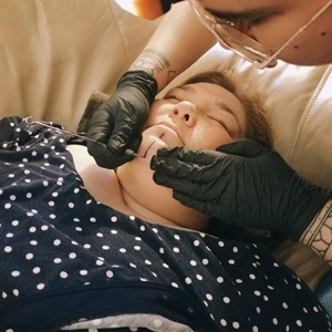 Traditional chin tattoo (tunniit) done in Iqaluktuuttiaq, 2021