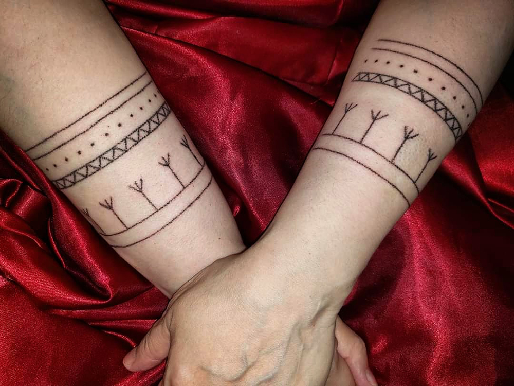 Traditional family wrist tattoos done in Iqaluktuuttiaq, 2021