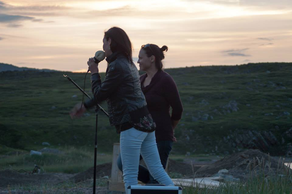 Evie Mark and Akinisie Sivuraapik performing on the beach, 2014