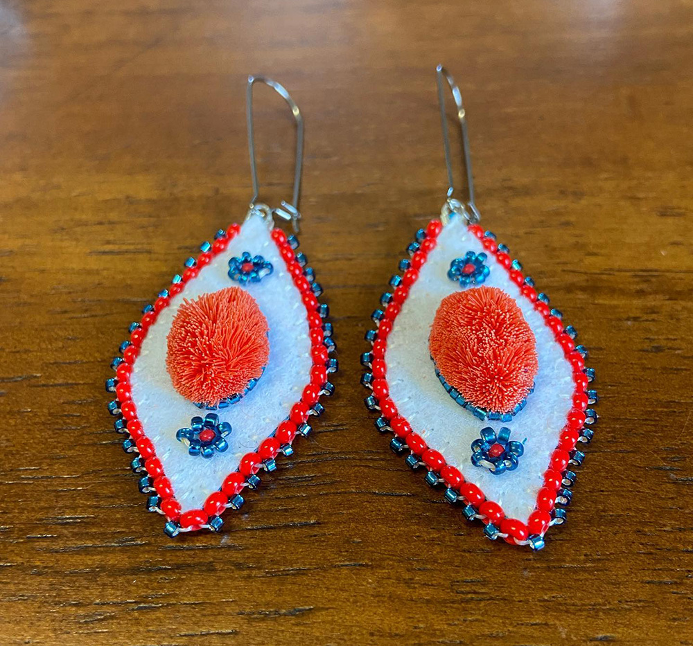 Red caribou-hair tufted earrings (2021)