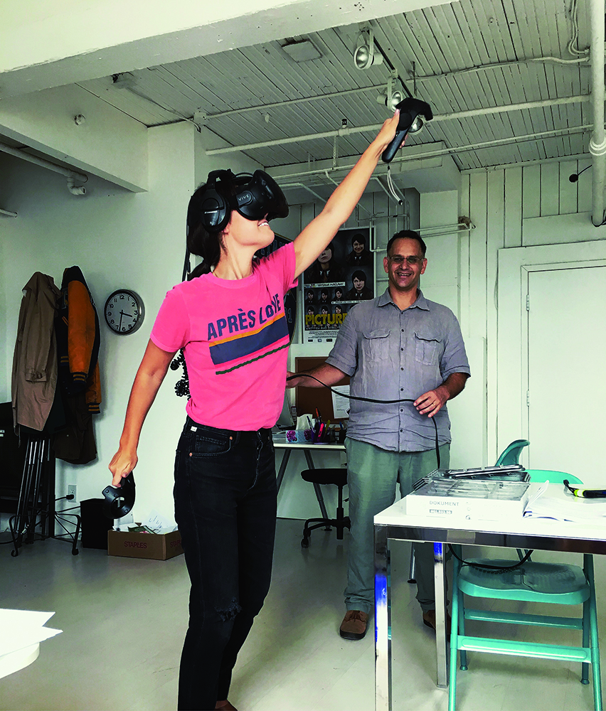 wearing a VIVE VR headset immersed in a virtual reality experience, 2018