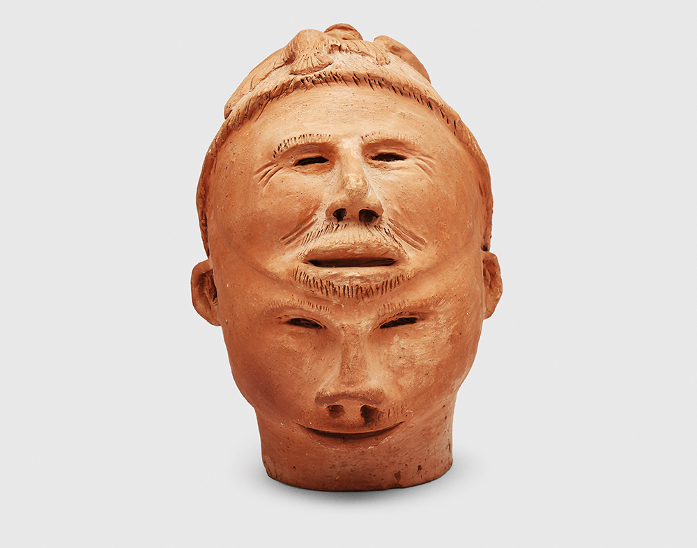 KukshoutPieTwoFacedHeadWithCLimbingFigureAndBirdDetail