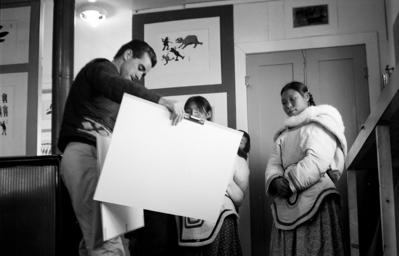 Terry Ryan, Sheouak Petaulassie with a child, and a woman at West Baffin Co-operative, Kinngait, Nunavut.