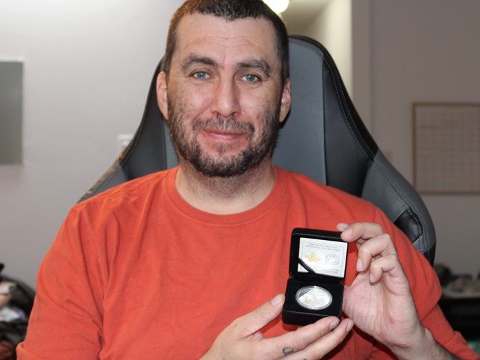 SikoakJason holding coin